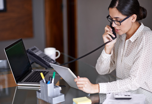 A receptionist talking on the phone.