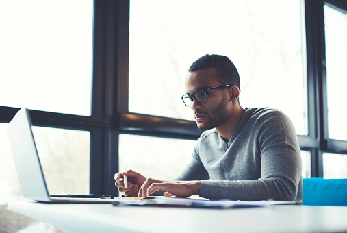 A man typing on a laptop.