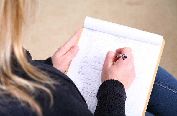 Woman filling out insurance paperwork